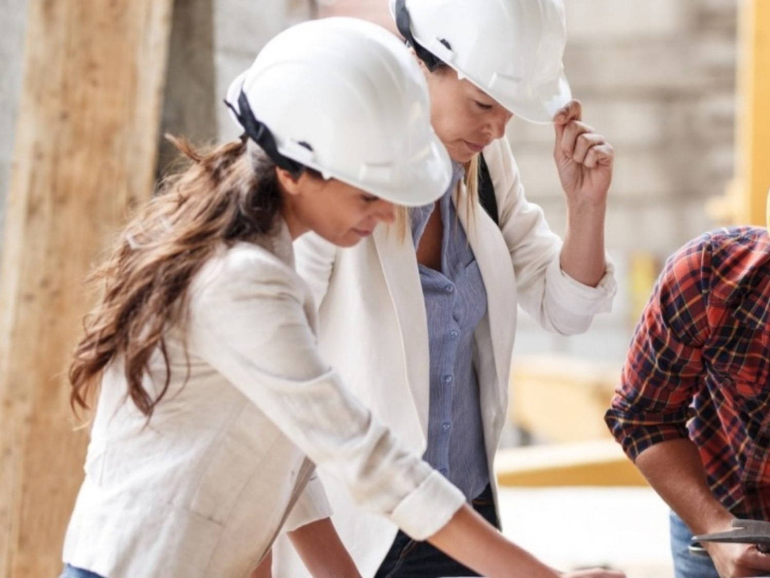 females on construction site wearing hard hats