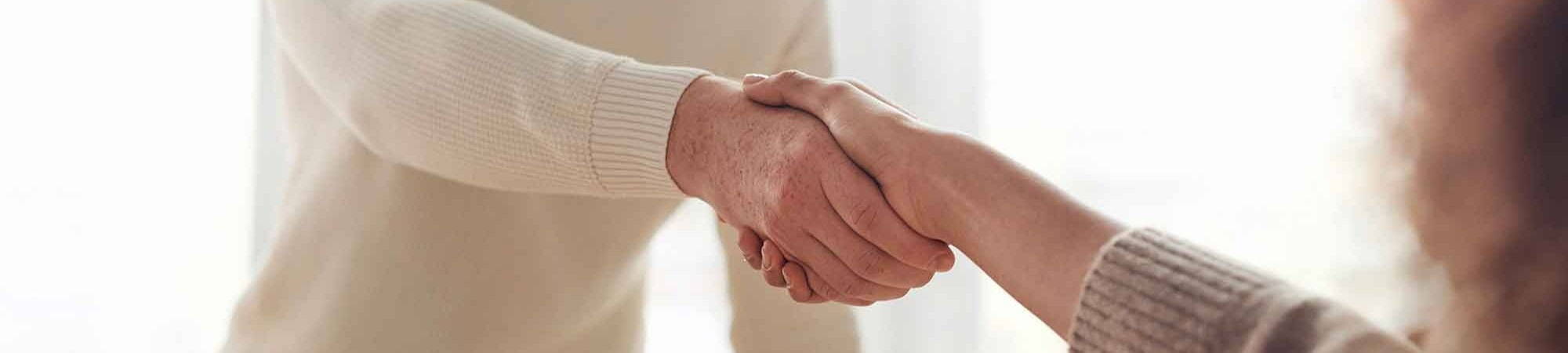 man and woman shaking hands in interview