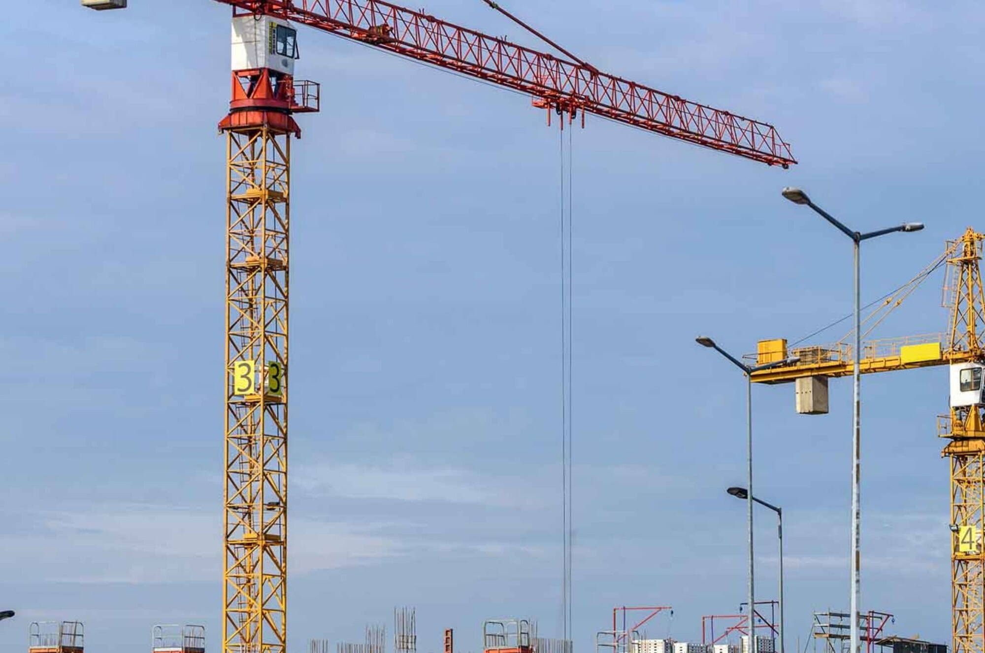 cranes against blue sky