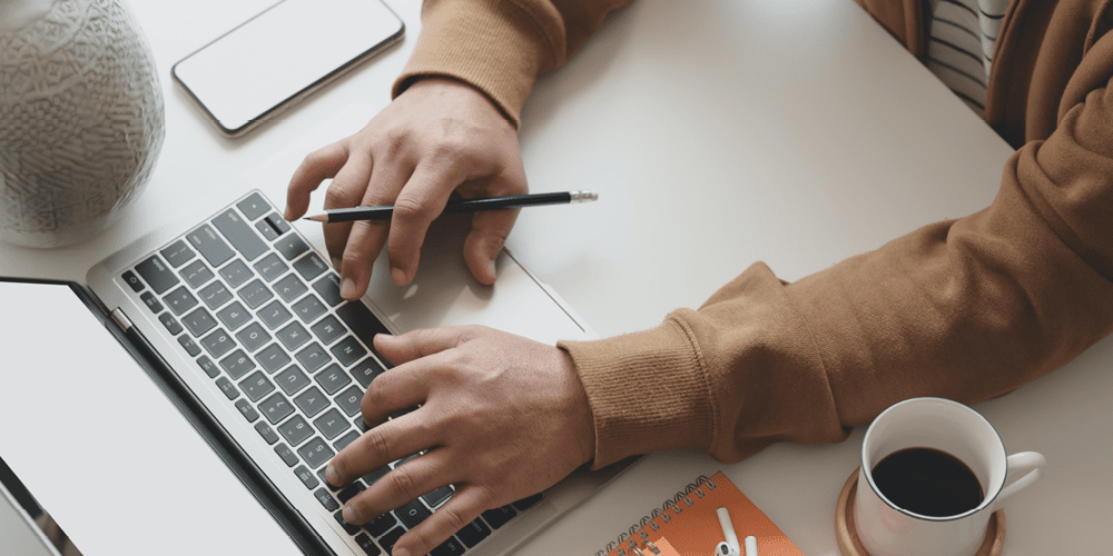 Woman writing on laptop